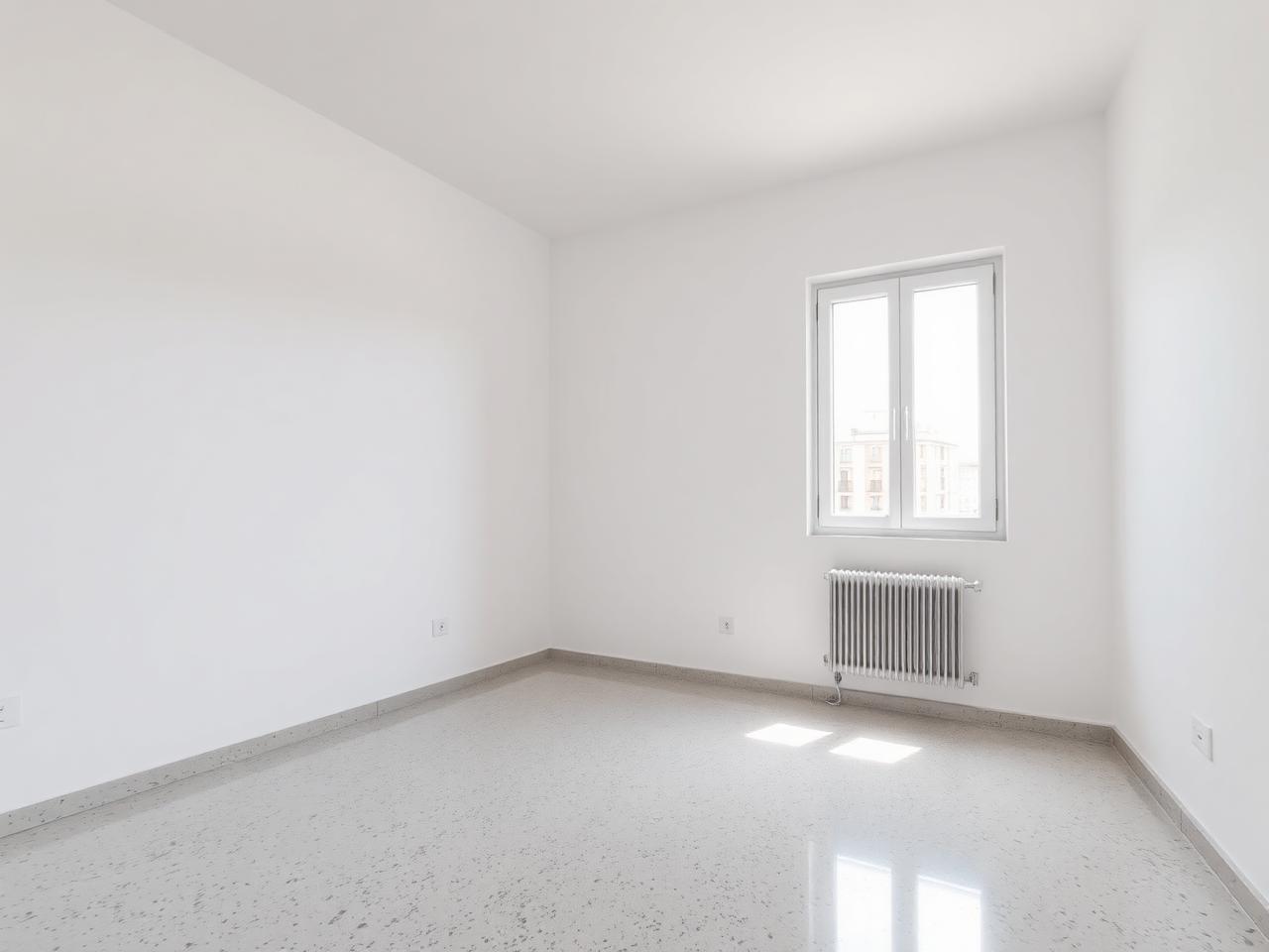 La misma habitación con las paredes alisadas y pintadas en blanco